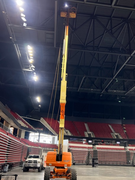Crane lifting pre-engineered metal building components into place