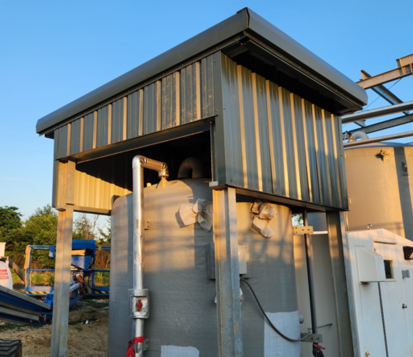 Construction consultants reviewing blueprints on a job site